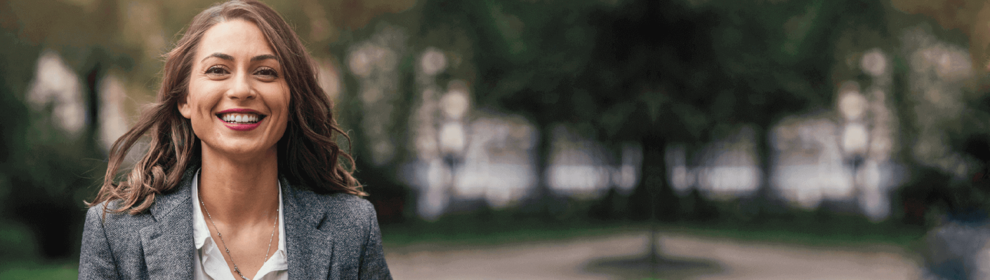 A woman in a suit smiling