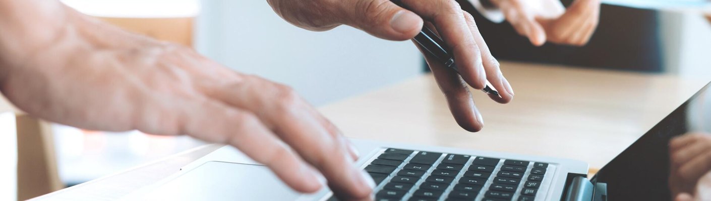 A person typing on a laptop