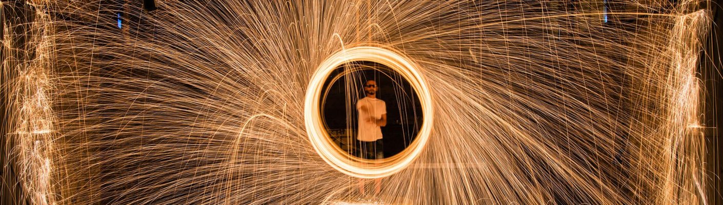 A person surrounded in a ring of fireworks
