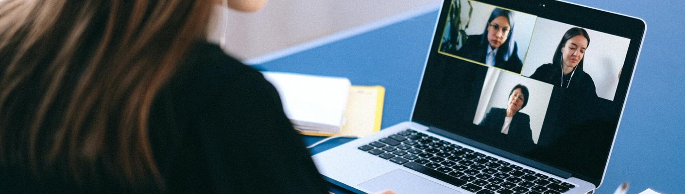 A person using a laptop to conduct a video conference call