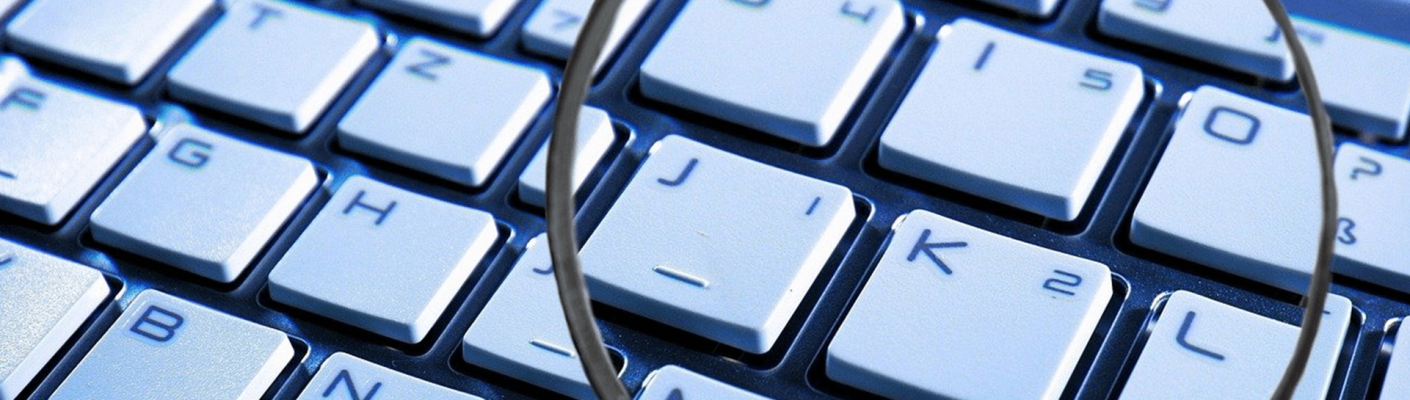 A magnifying glass over a keyboard