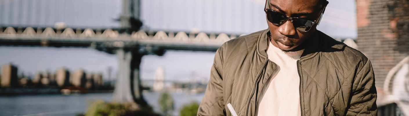 A person with a city bridge in the background
