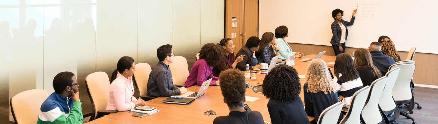 A group of people in a board meeting