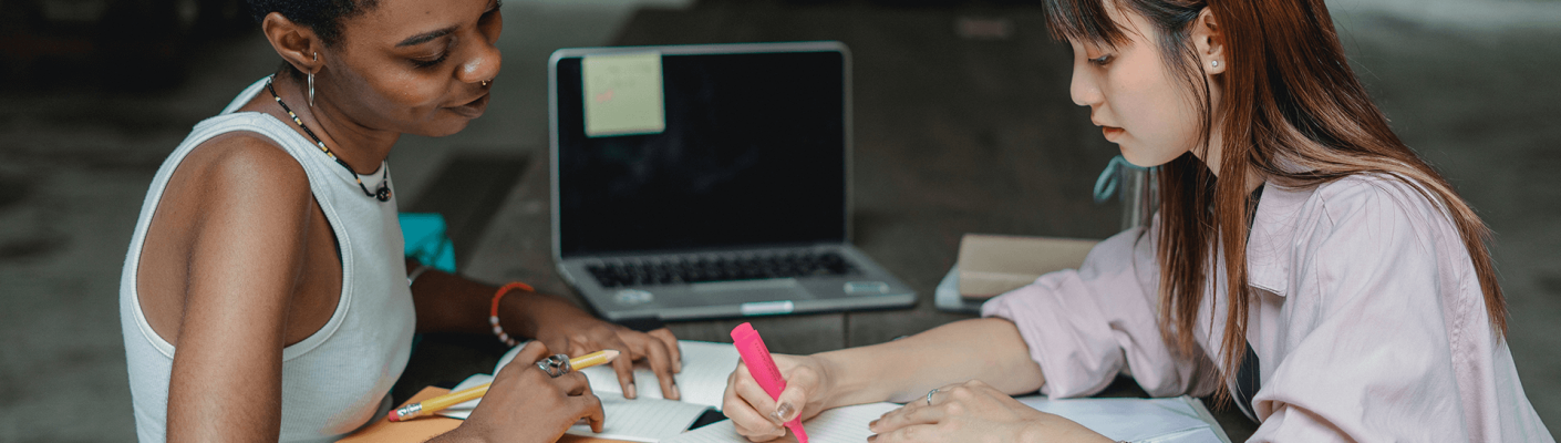 Teacher helping student with work - Tulane School of Professional Advancement