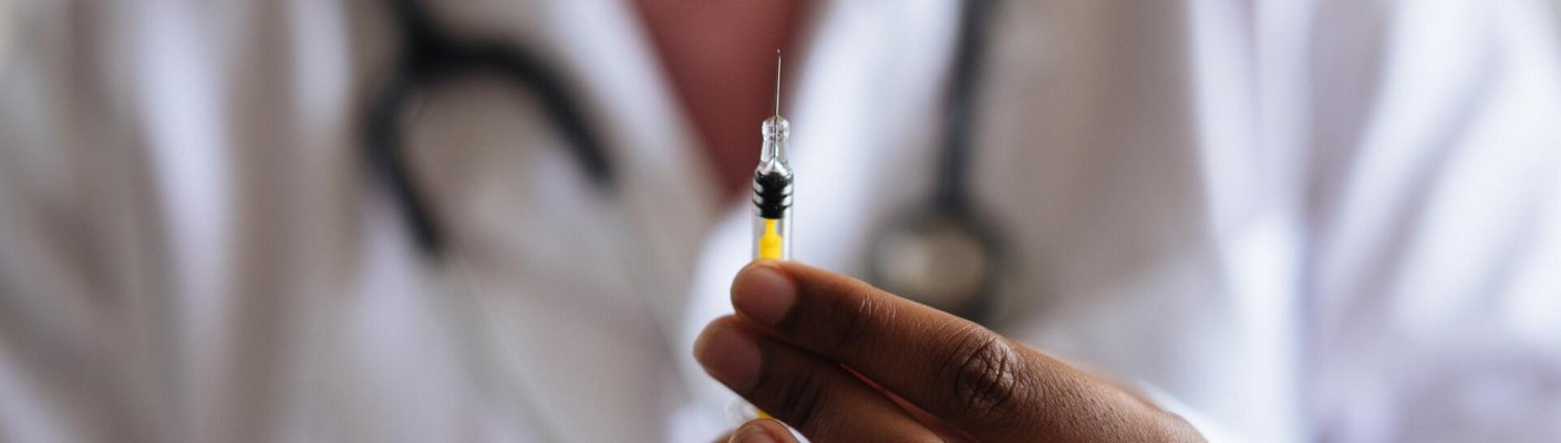 A doctor holding a syringe
