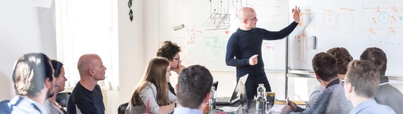 A man teaching a class at a whiteboard representing the chief IoT officer program at Tulane School of Professional Advancement in New Orleans, LA