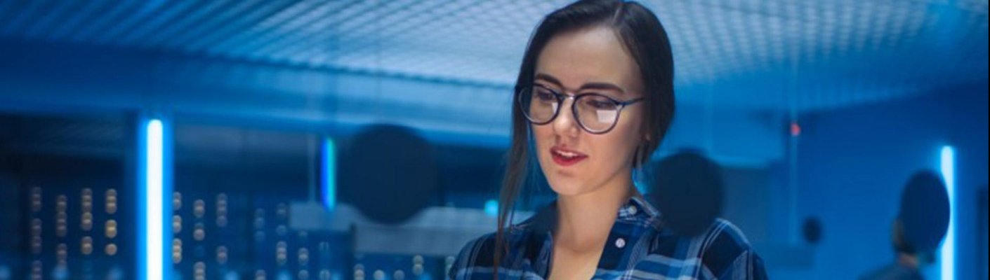 Cybersecurity analyst working in a data center.