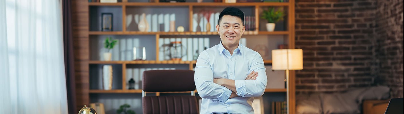 A professional posing for a photograph in an office