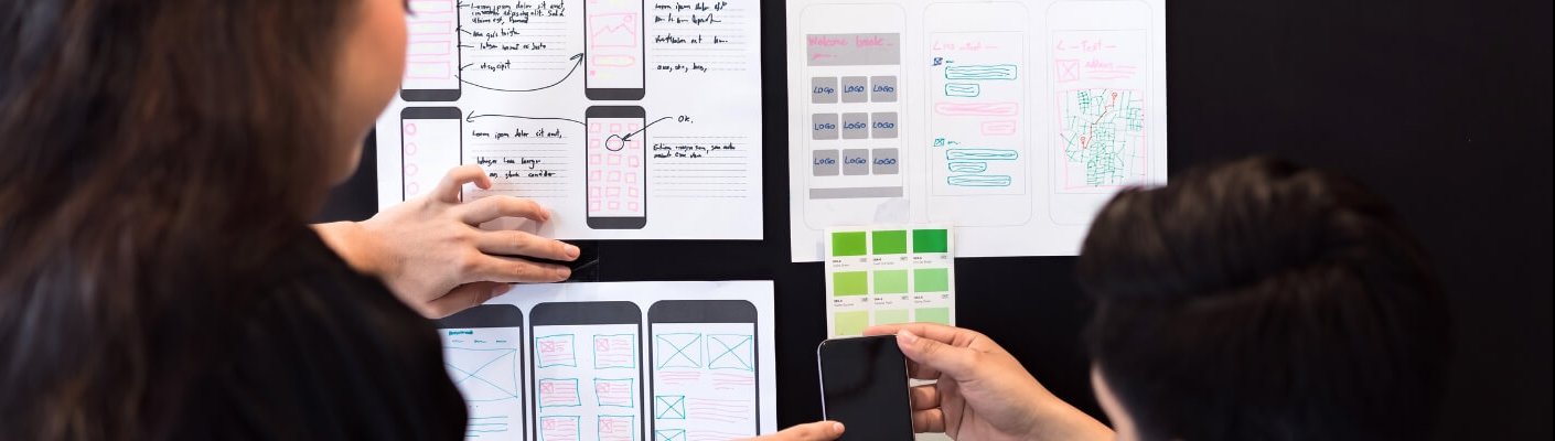 People working on UI/UX wireframe designs