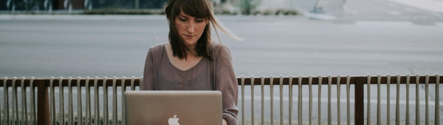 A student working outside on a laptop