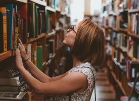 A woman in a library representing master's degree programs at Tulane School of Professional Advancement in New Orleans, LA