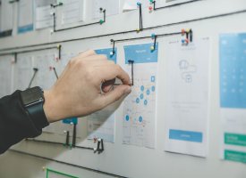 A person making a push-pin graph