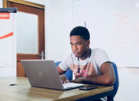 A student using their laptop in a classroom