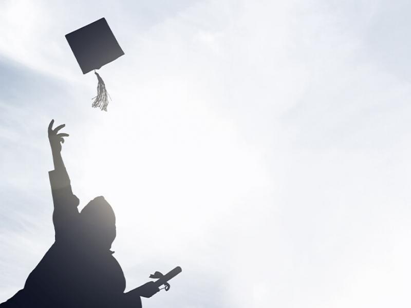 Graduate throwing cap