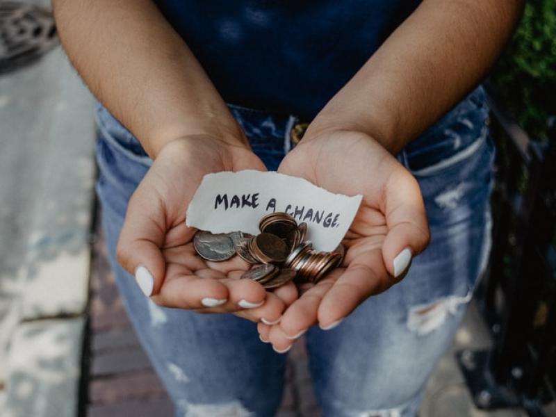 Hands holding change and a note that states 'Make a change'