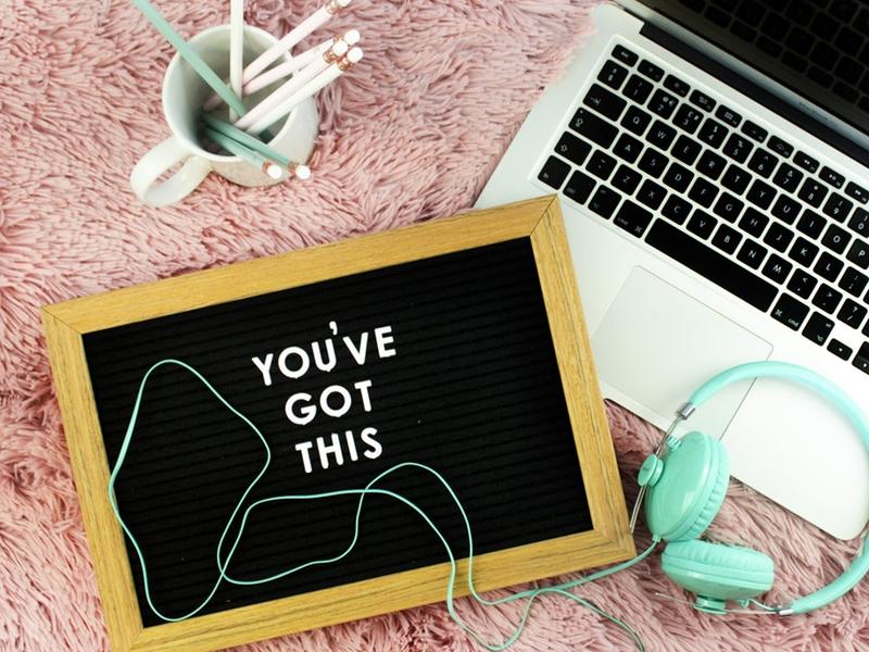 A chalkboard next to a laptop that says 'You've Got This'
