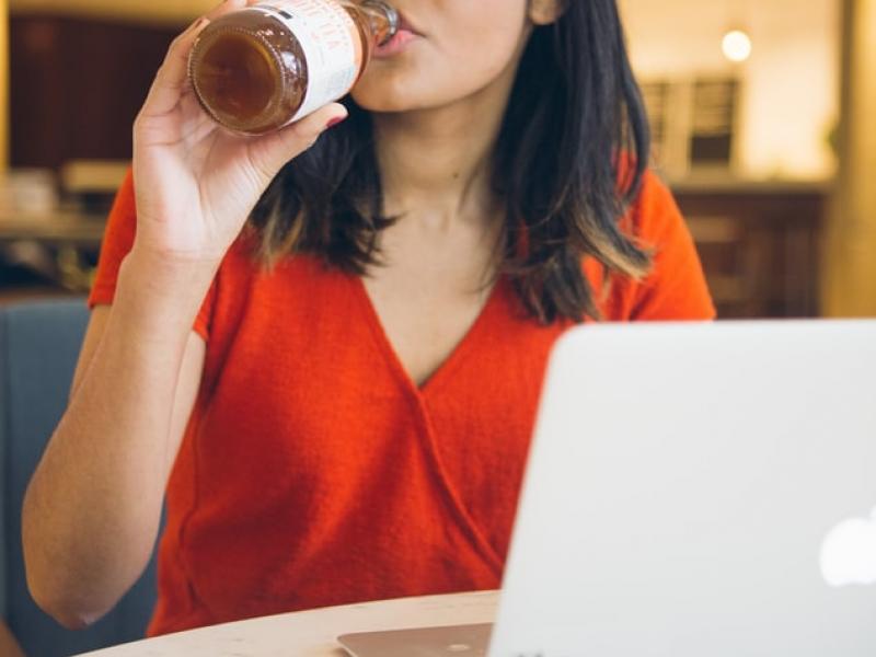 A student drinking a health drink while studying