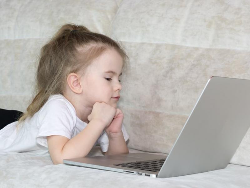 A child looking at a laptop