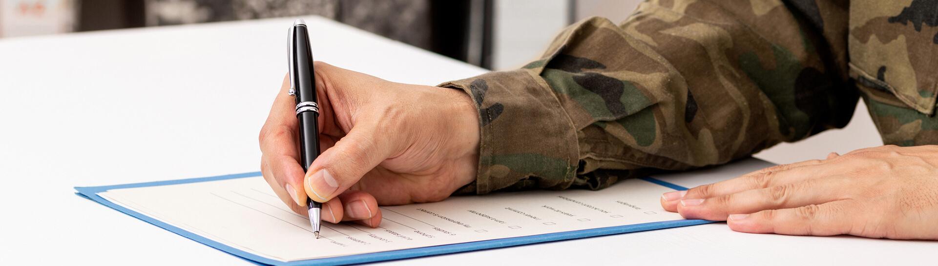 Veteran filling out a paper form - Tulane School of Professional Advancement